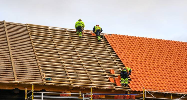 roof being laid three people