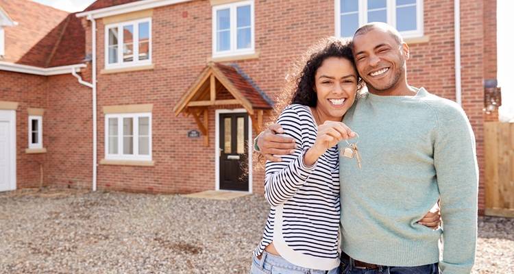 Couple in front of house