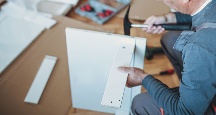 man installing flat pack drawers