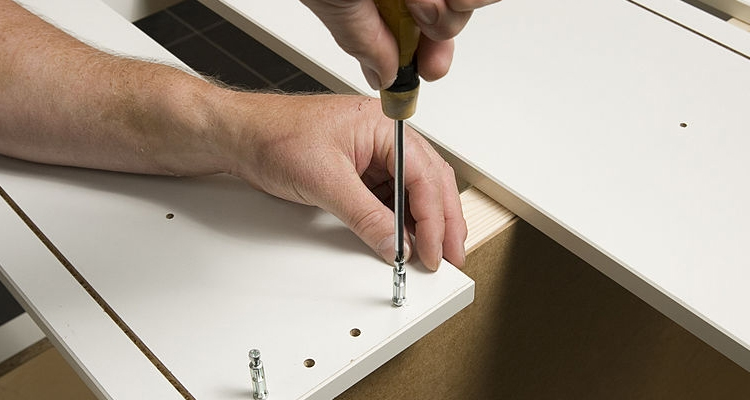 man assembling flat pack cabinet