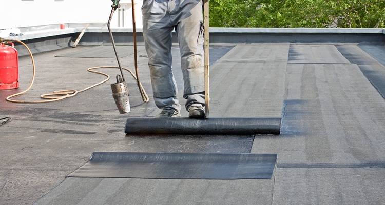 man replacing felt roof