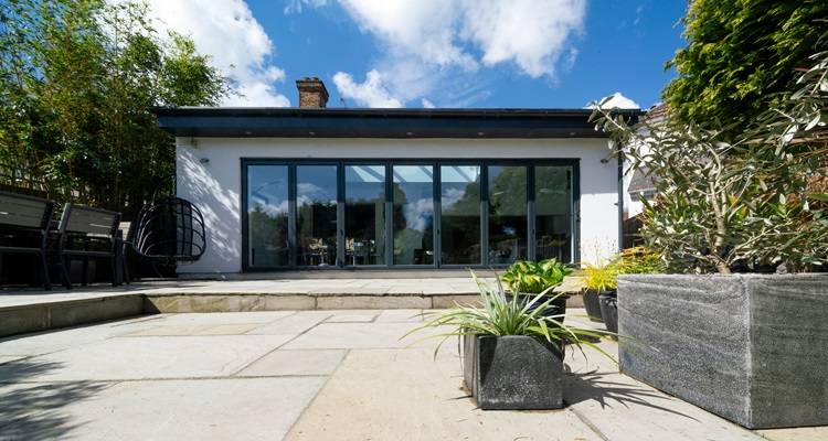 garden room cost guide &mdash; front of a garden room next to a patio