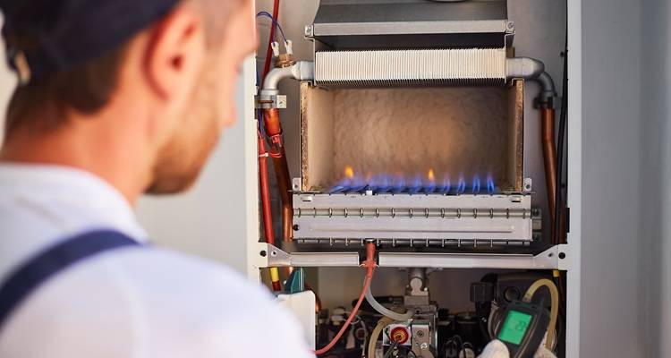 man in front of boiler burners