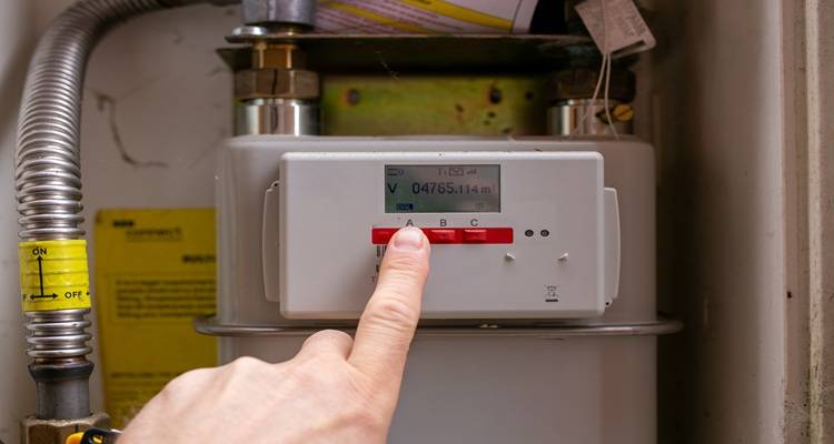 Hand on gas meter