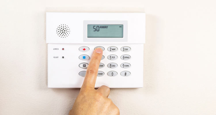 closeup of a person entering in a code to a home security system installation