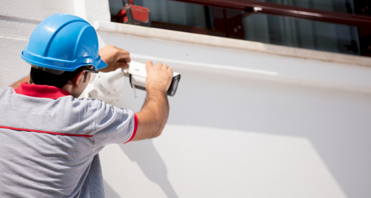 tradesperson installing a CCTV system