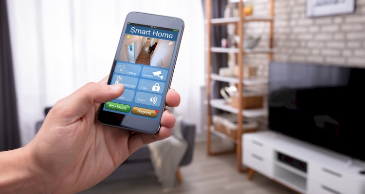 homeowner monitoring a home security system's feed from their phone