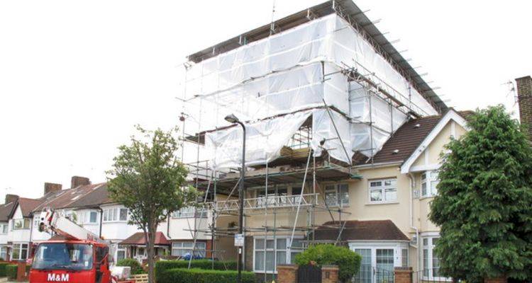 house extension cost guide &mdash; a large extension being added to a UK home