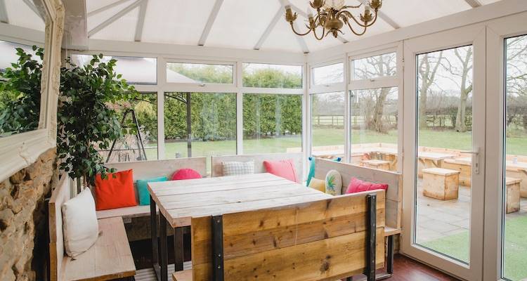 house extension cost guide &mdash; a conservatory that is being used as a dining area