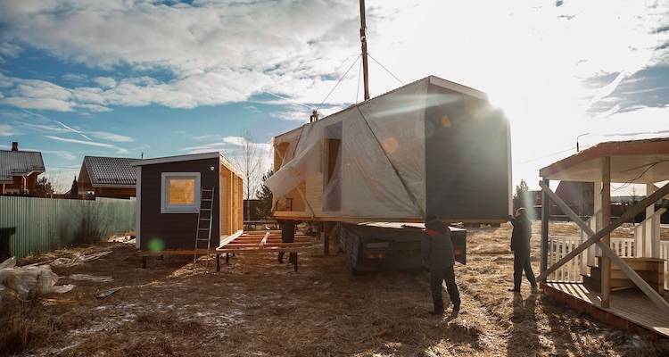 house extension cost guide &mdash; modular extension being lowered by a crane