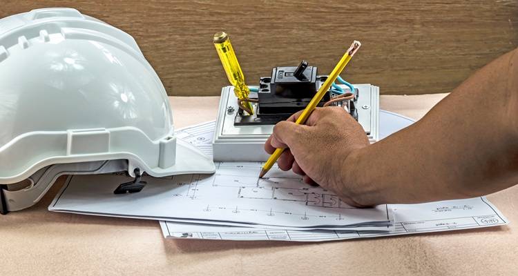 white hard hat hand plans