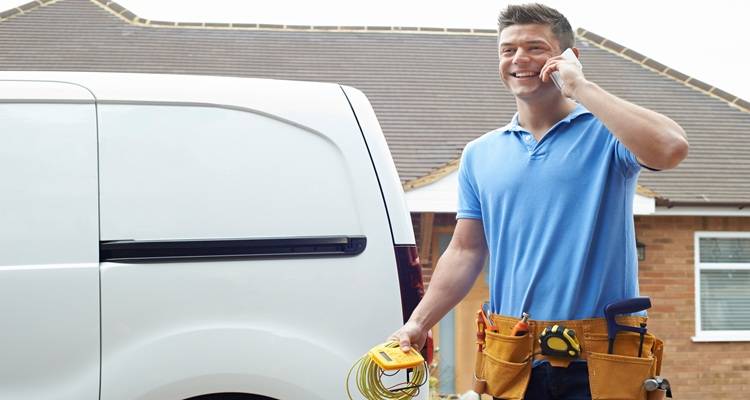 electrican outside van on phone