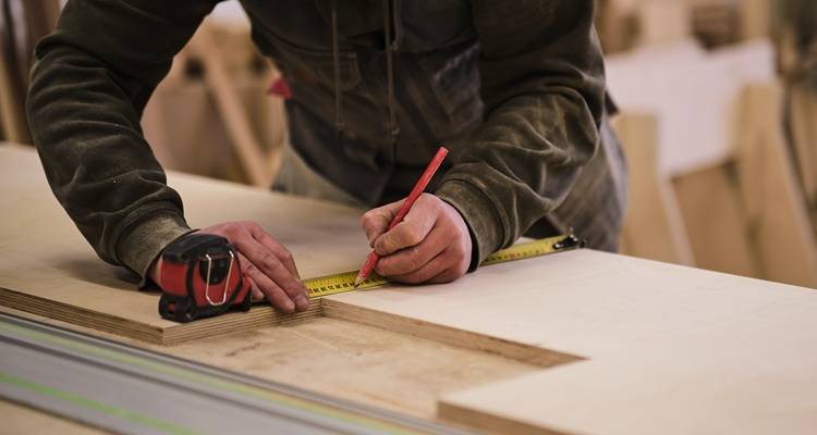 man marking wood