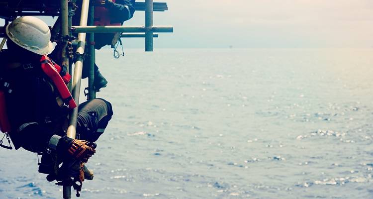 men at sea on scaffolding