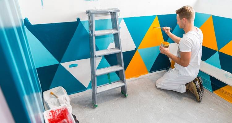 man painting walls