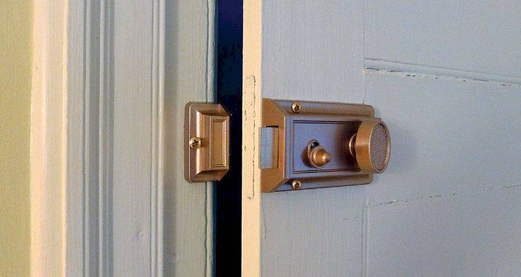 example of a rim automatic deadlatch on a wooden door