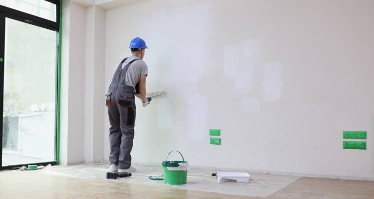 man painting wall