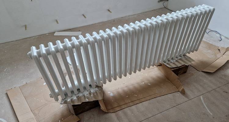 radiator that has been removed from the wall and painted