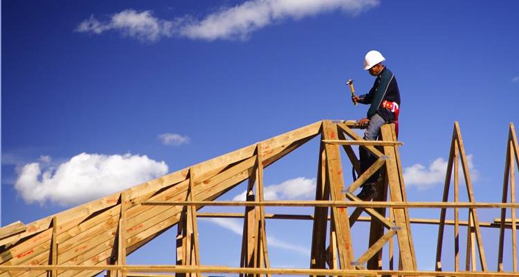 man on roof joists