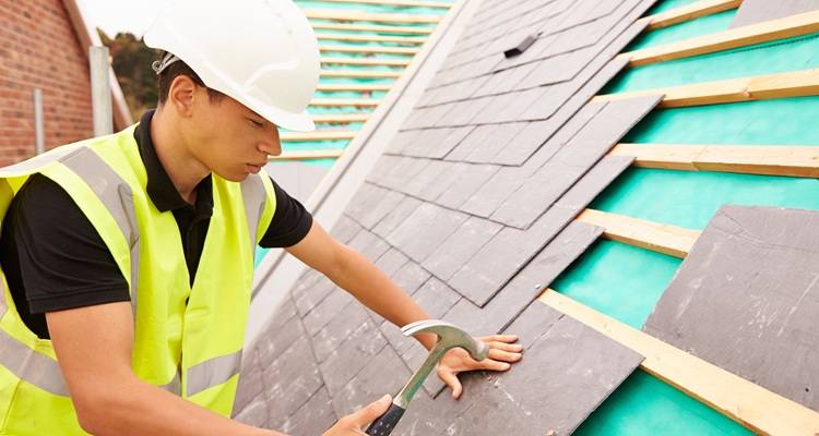 roofer laying tiles