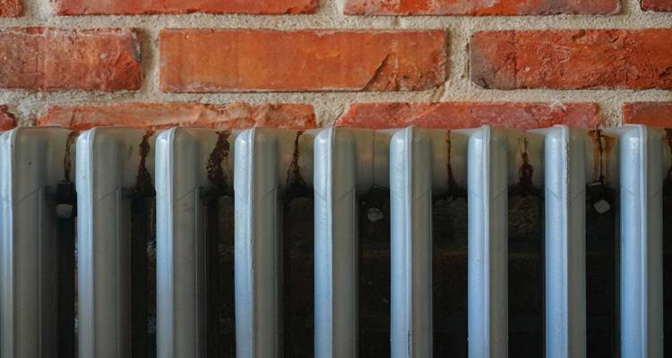 cast iron radiator brick wall