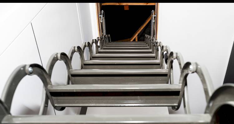 closeup view from the bottom of a loft ladder installation looking into the attic space