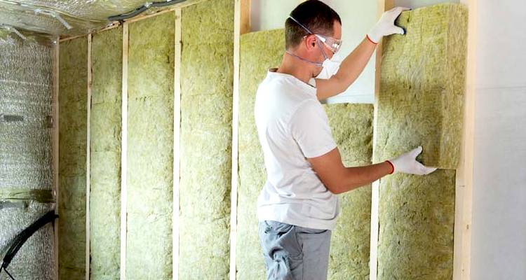 ground source heat pump cost guide &mdash; cavity wall insulation being installed by a tradesperson