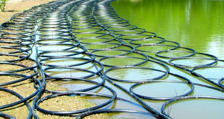 ground source heat pump cost guide &mdash; heating coils laid on floor outside