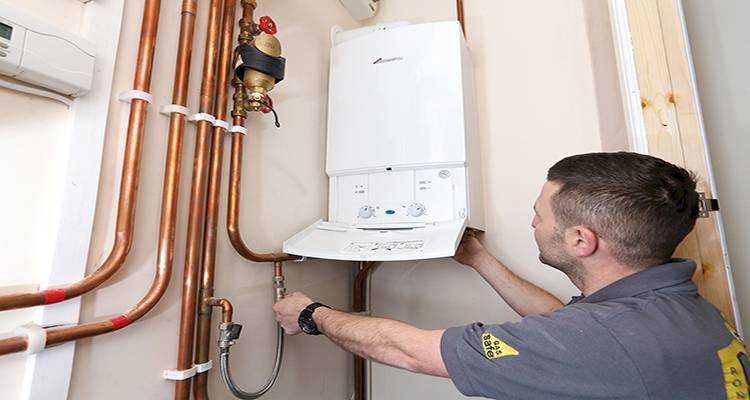combi boiler installation cost guide &mdash; tradesperson installing a combi boiler