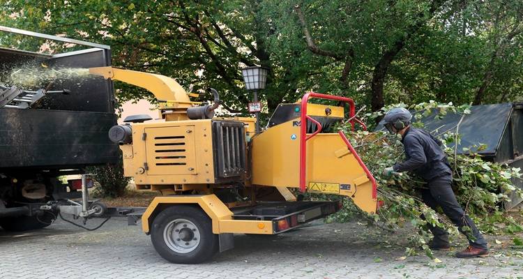 man woodchipper back of truck