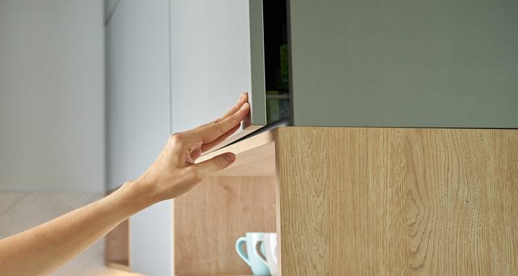 hand on cupboard door