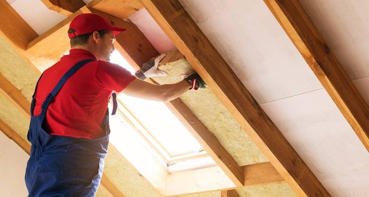 man installing loft insualtion
