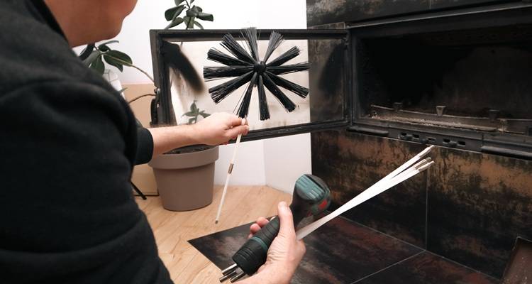 hand cleaning out sweeping burner