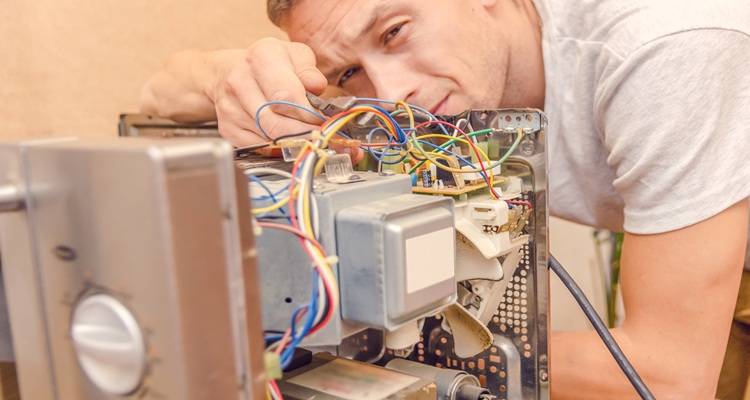 man behind opne microwave