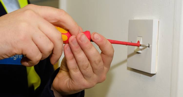 person fitting lightswitch
