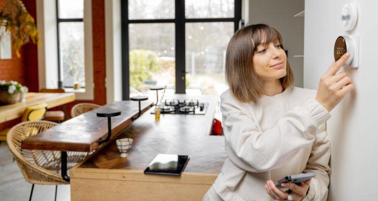 woman using nest thermostat