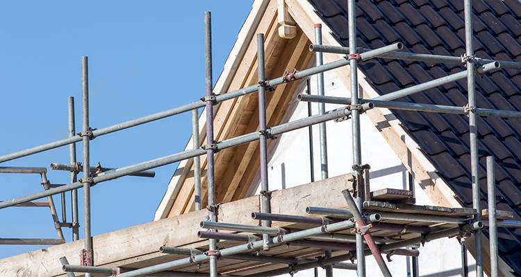 scaffolding that has been put up around a detached home in the UK