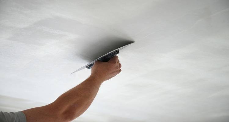 white ceiling skim hand