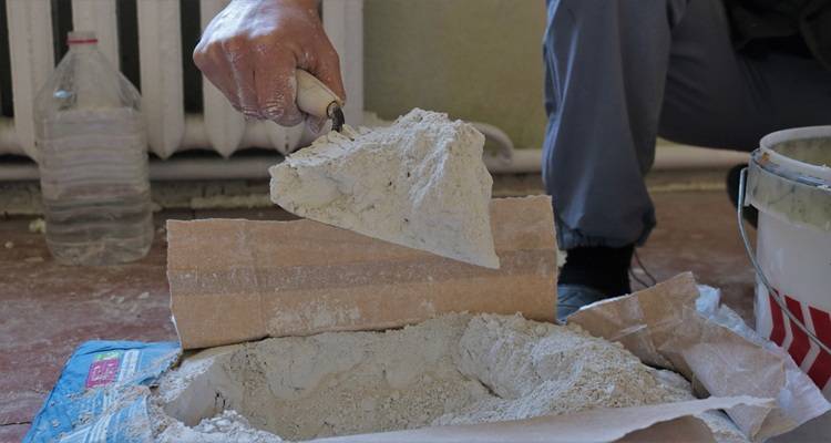 trowel and open bag of plaster