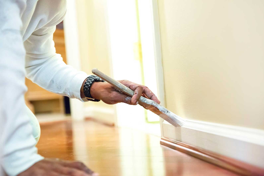 person painting skirting boards