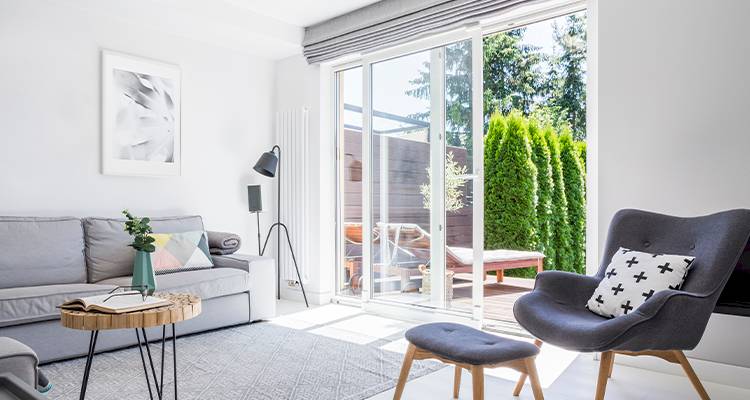 open white framed patio doors leading out to a garden