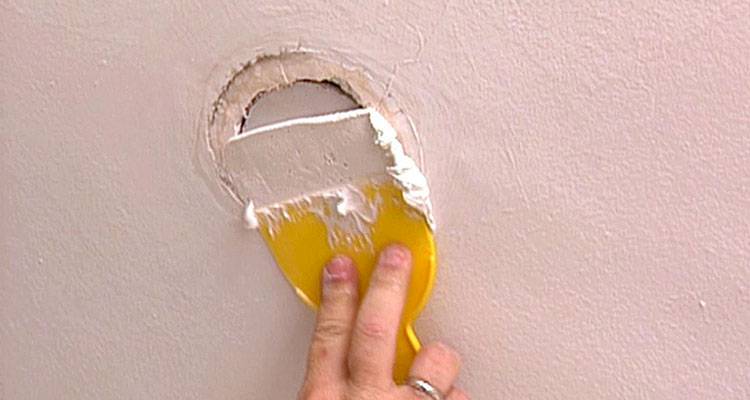 plasterer fixing wall crack