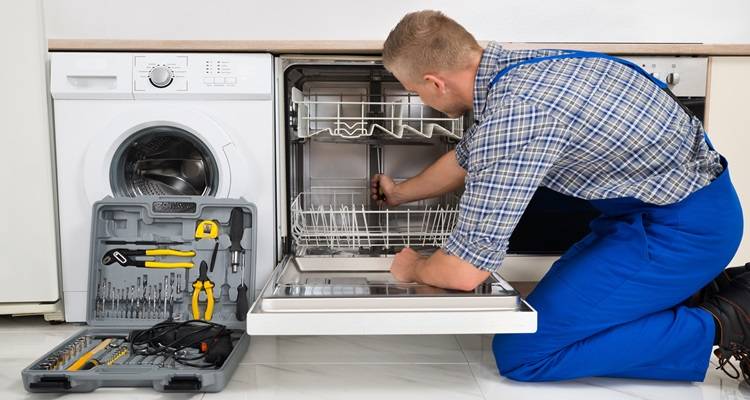 plumber fixing dishwasher