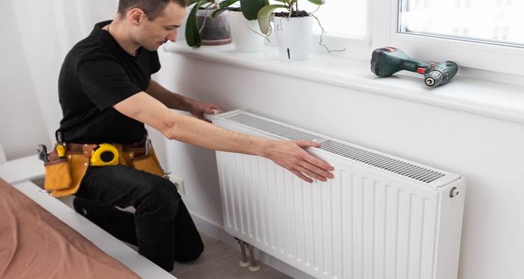 man installing radiator