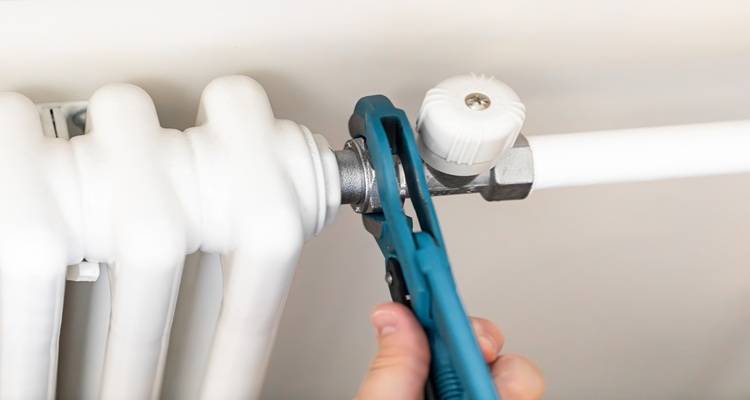 close up radiator pipe tool hand