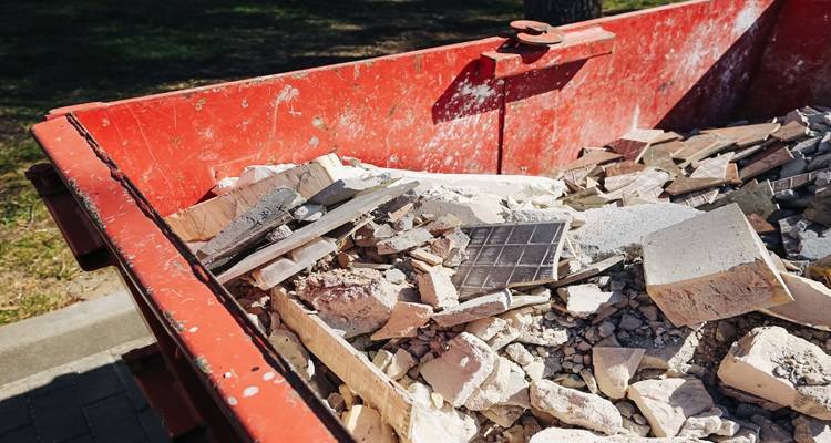 red skip with construction debris