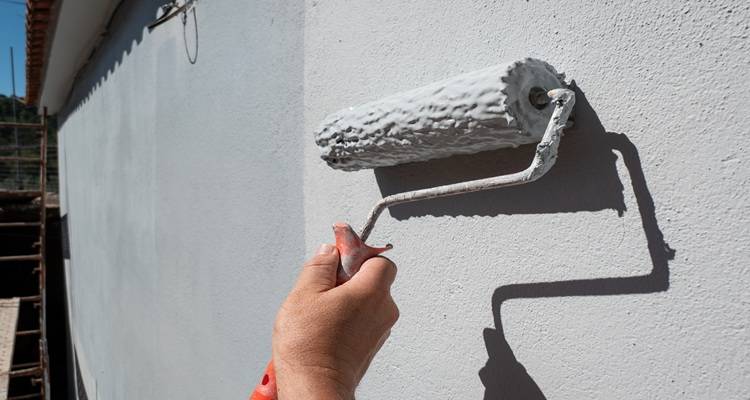 roller painting outside wall