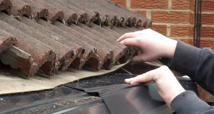 closeup of a tradesperson who is replacing eaves felt