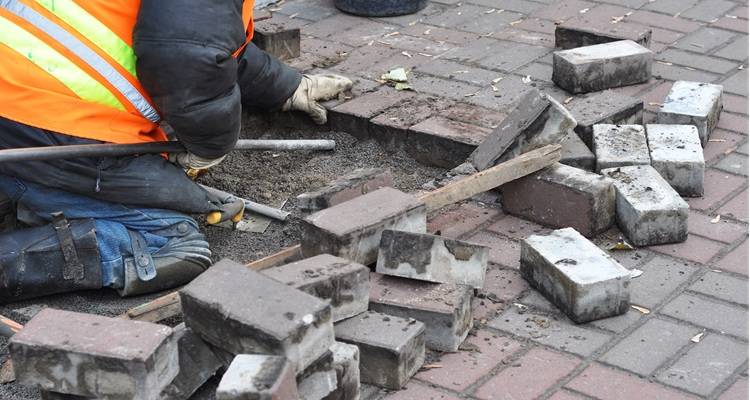 block paving repairs person kneeling