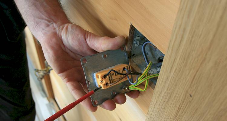 electrician that is fitting a light switch